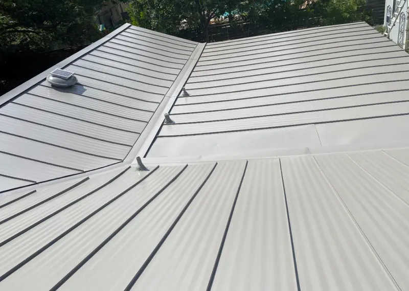 Solar attic fan installed on a metal roof for Roof Ventilation in Cherokee